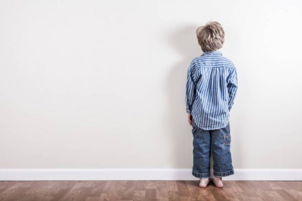 Punishment, boy facing the wall