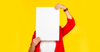 No advertising, woman holding blank card over face