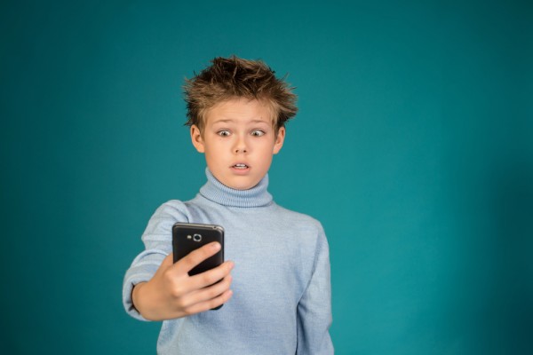 Shocked child using smartphone