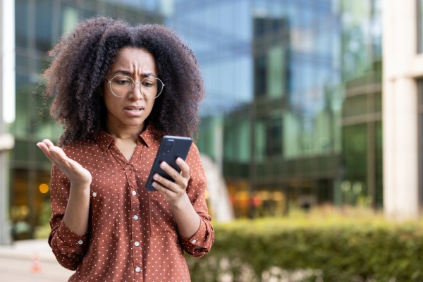 Woman reading disturbing message on phone, direct marketing, PECR, enforcement, sales, blog, course materials